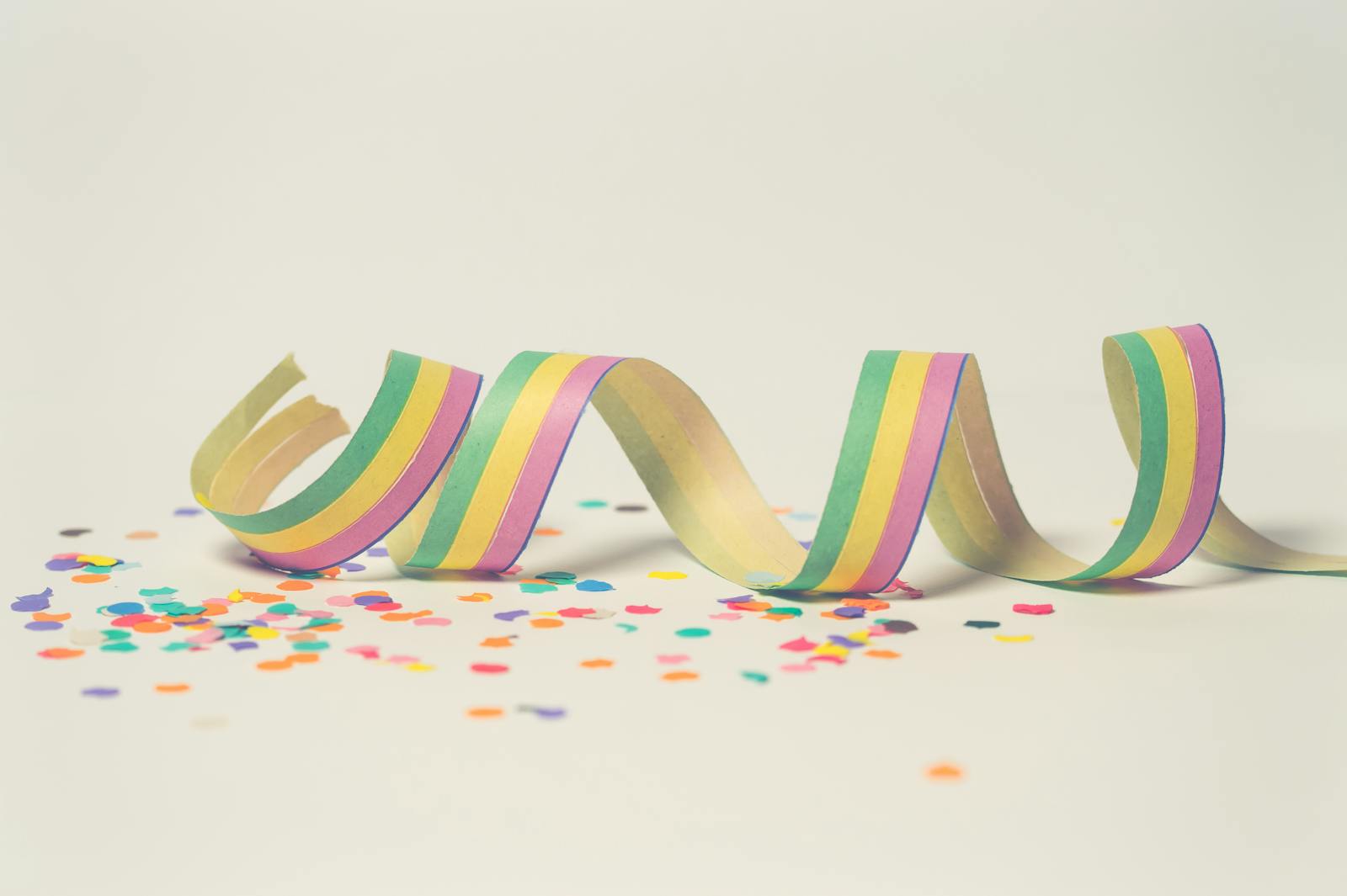 Bright pastel paper streamer with scattered confetti, perfect for celebration themes.